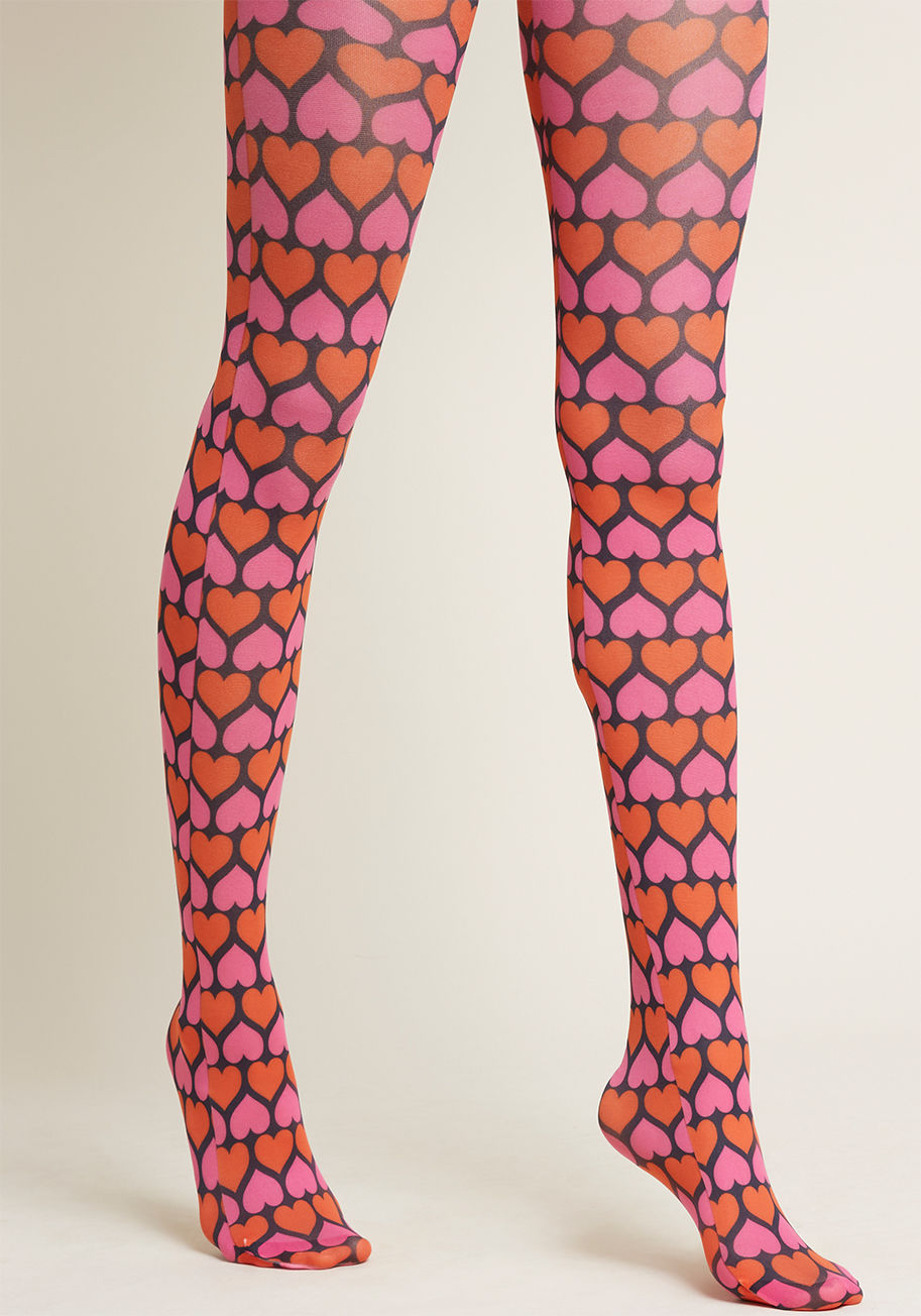 3314 - These black tights sure do know how to elicit a positive response! Patterned from hip to toe tip with a medley of red and pink hearts, this quirky hosiery is adorable