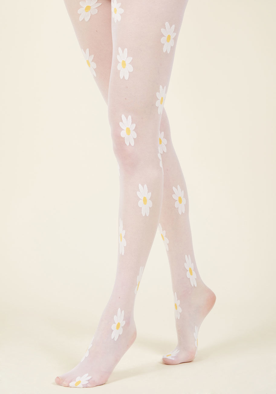 7928 - A sunny forecast is more than just great news - it's an opportunity to full-on flaunt these white tights! The sheer look of this chipper hosiery allows its patches of yellow-centered daisies to pop against your stems, and permits this pair to receive all 