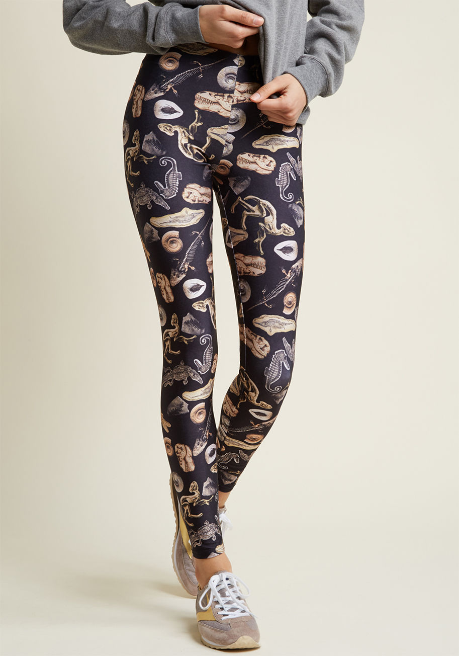 Dino Fossils - From the terrace to the treadmill, these black leggings stylishly take the scene by storm! Sturdy, stretchy, and scattered with fossils aplenty, these high-shine and eye-catching bottoms have a versatile va-va-voom.