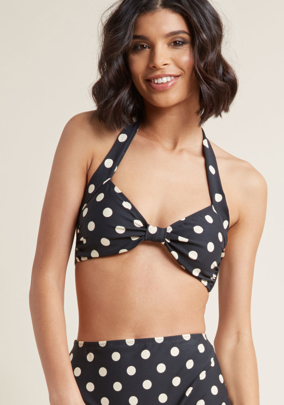 E09006T - Inspired by our favorite beach party film, this washed black swimsuit top is flattering on many body types. Designed by the iconic Esther Williams to feature whimsical ivory polka dots, supportive side boning, and touches of ruching, this sassy, ModCloth-