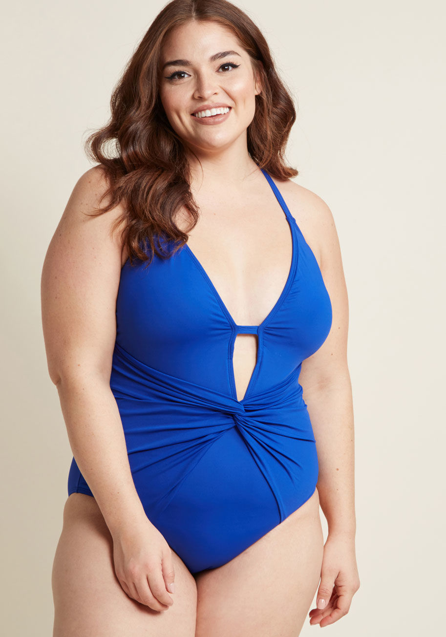 LB8LA29W - Why daydream about a fabulously flattering swimsuit when you could just as easily wear this cobalt blue one piece? This sultry swimsuit by La Blanca wows with a plunging neckline, knotted waist detail, and shoulder straps that cross within its open back. 