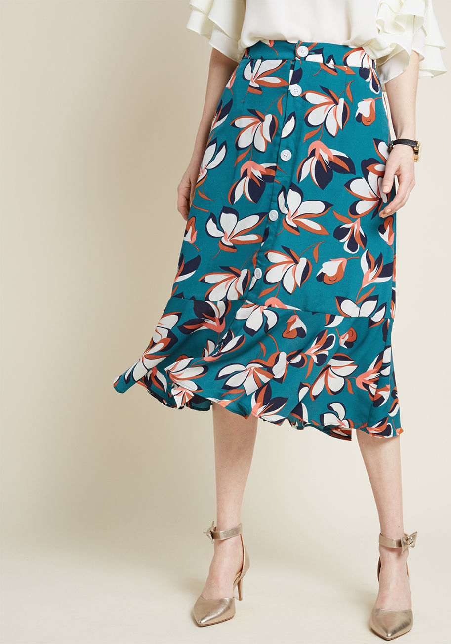 MDB1058 - This woven skirt from our ModCloth namesake label is a collection of charming details that flatter from the cubicle to the cruise ship! With an elasticized back to its waistband, decorative buttons down the front, a ruffled hemline featuring a front vent,