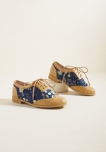 It seems like just yesterday that your first pair of oxford flats entered your wardrobe. Now, you've evolved to wearing such statement-making wingtips as this floral pair! Made from blond faux leather, with navy blue fabric inserts patterned with white an by Daisy