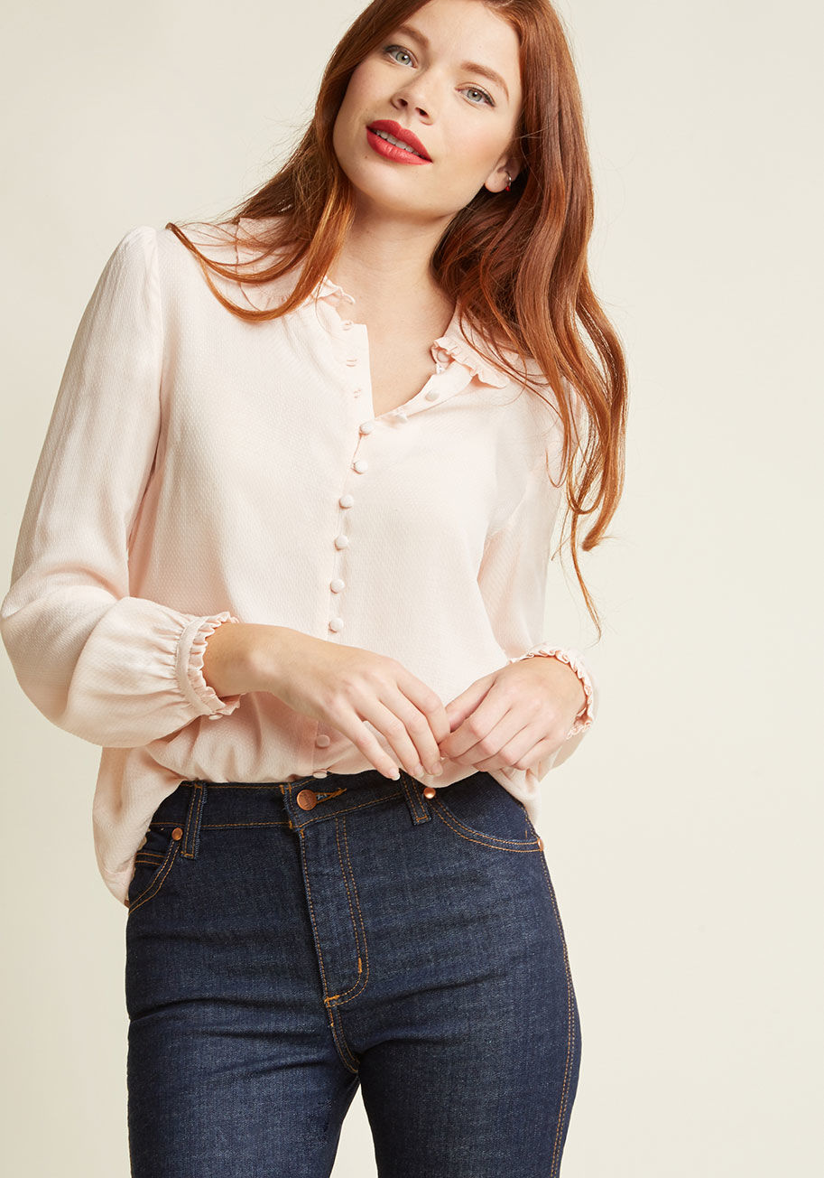  - A feminine nod to the fashionable past, this delicate pink blouse makes for a blissful wearing experience! Sweetened up with a ruffled, rounded collar and coordinating sleeve cuffs, a decoratively fastened bodice with functional top-five buttons, and a li