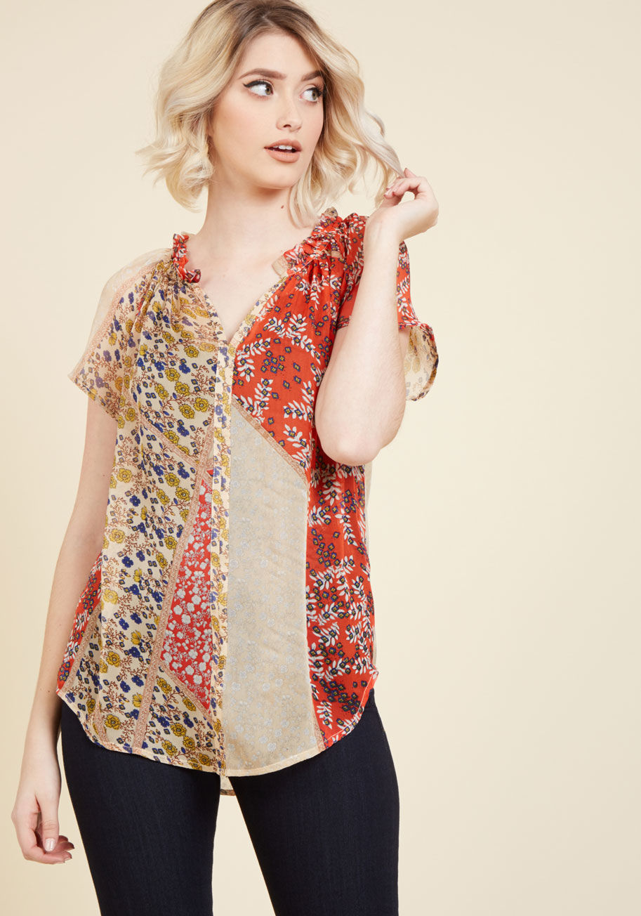  - A print here is fun, a pattern there is playful - but an array of colors and designs all atop one blouse is brilliance! This sheer blouse exemplifies such with its paprika, taupe, navy, and marigold hues mingling between neckline ruffles, soft flowers, an