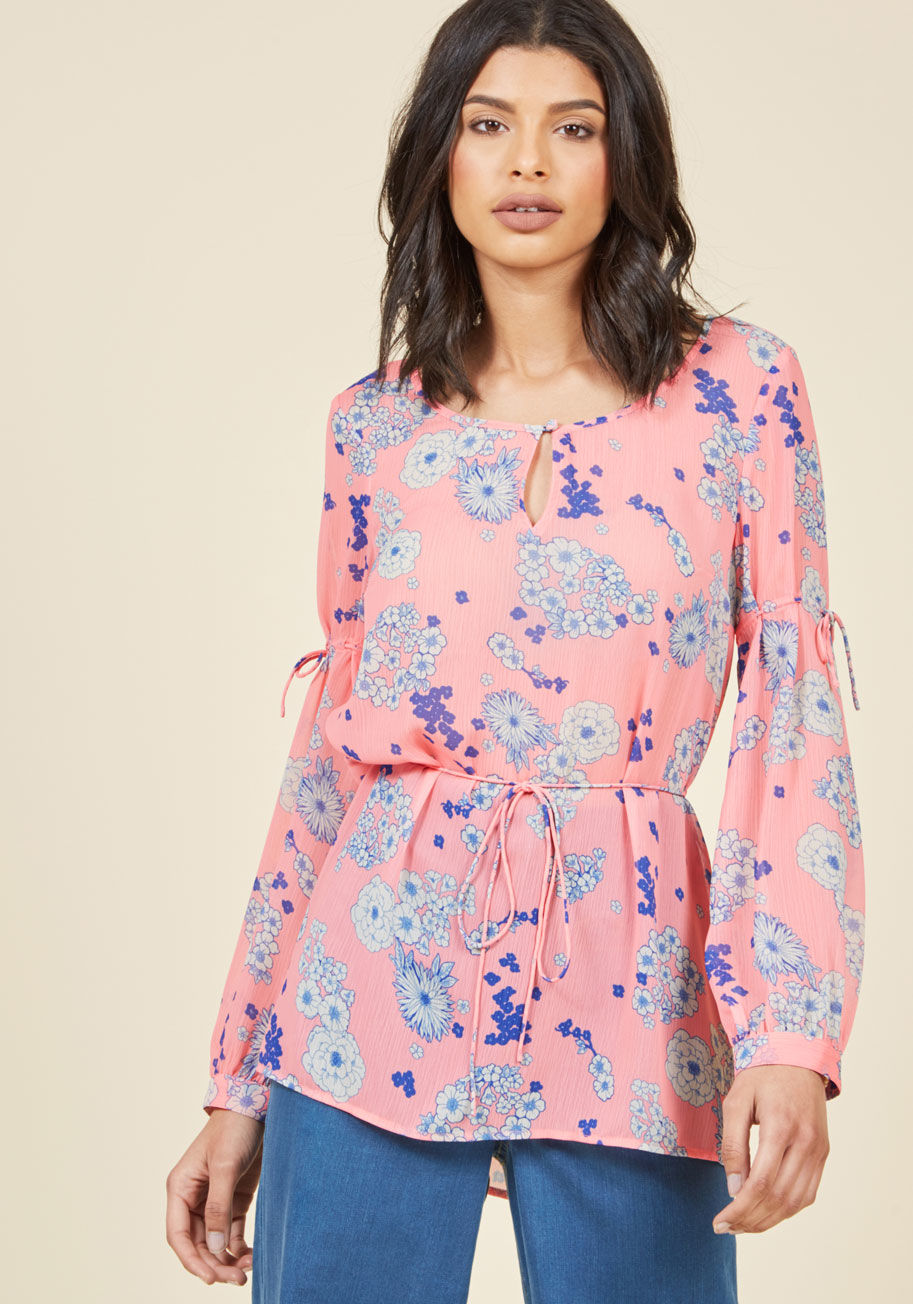  - After finalizing your itinerary and packing your suitcase, all that's left to do is slip into this sheer blouse from our ModCloth namesake label! The neckline keyhole, blue-and-white florals, and thin waist tie of this pink top ensure style on arrival, wh