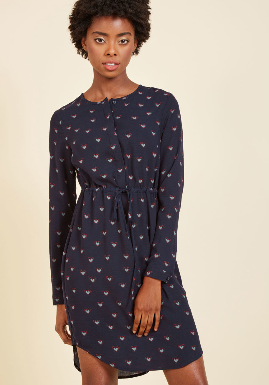  - After years of fashion experimentation, you've learned quite a few things - most notably, the importance of a good shirt dress! This navy number from Sugarhill Boutique - with its concealed placket, drawstring waist, and blue-and-red heart pattern inspire