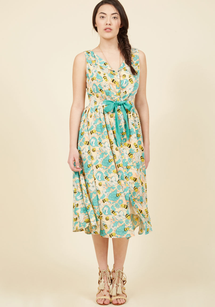  - All the buzz surrounding your pale yellow shirt dress is well earned! A lighthearted print of happy bees and aqua flowers breathe new life into the vintage-inspired design of this silky midi from Banned, as its front-tied waistline and swingy skirt round 