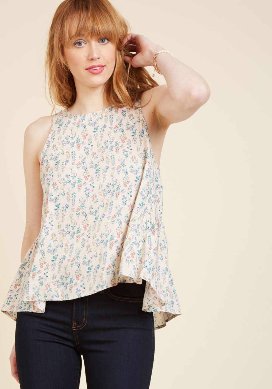  - An afternoon with your notebook and guitar has never looked so stylish as it does with this pale pink top on your frame! Fashioned with a buttoned back keyhole, peplum-inspired gathering below it, and a dainty floral print, this graceful piece has just as