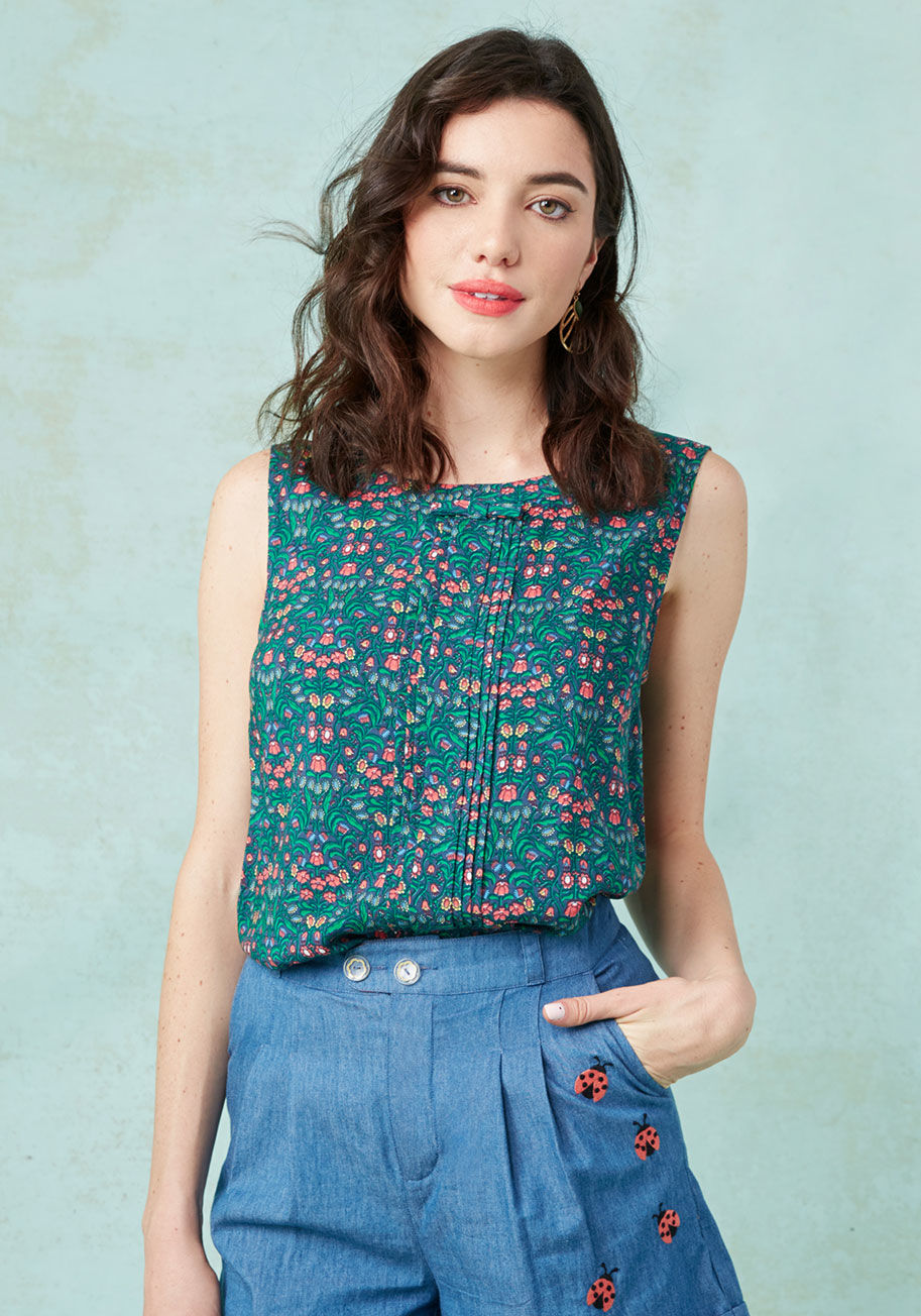  - Approach your favorite haunts with fresh eyes and the fabulous style of this feminine top! This ModCloth namesake label tank displays a red, green, yellow, and navy pattern of folksy flowers, a primly pintucked front panel, and a blissful collection of bo