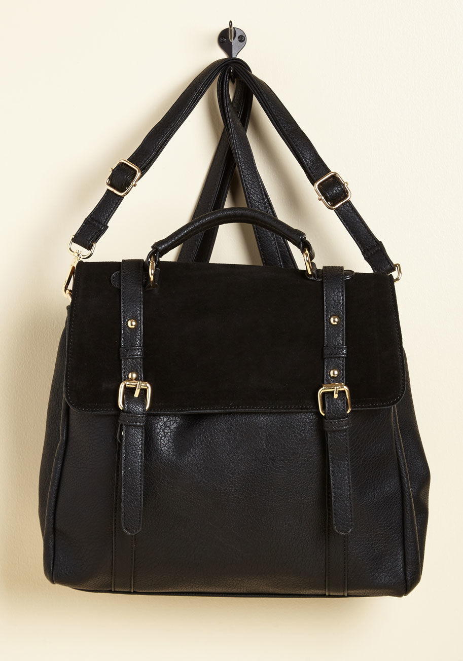 Can we all pause for a moment to appreciate the utter awesomeness of this rocker-chic bag? Equipped with two pocketed compartments, a suede flap that snaps shut, and the option to transform into a backpack, this brown, white, and black carryall is almost  by 