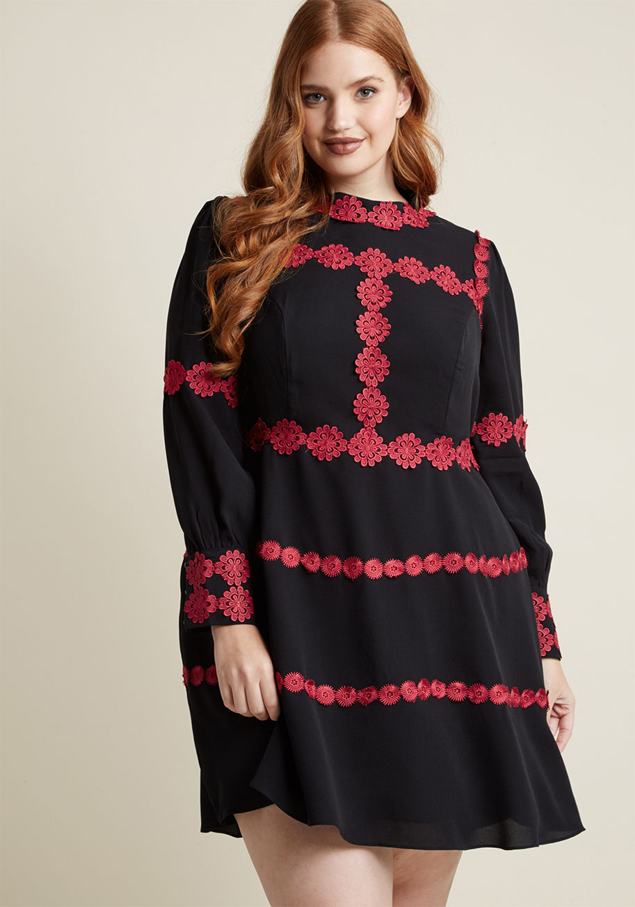  - Contouring your beautiful frame with crocheted magenta flowers, this long-sleeved black dress introduces loveliness to every aspect of your look. With a haute high neckline, flattering princess seams, and sleeve cuffs fastened with pearl-inspired buttons,
