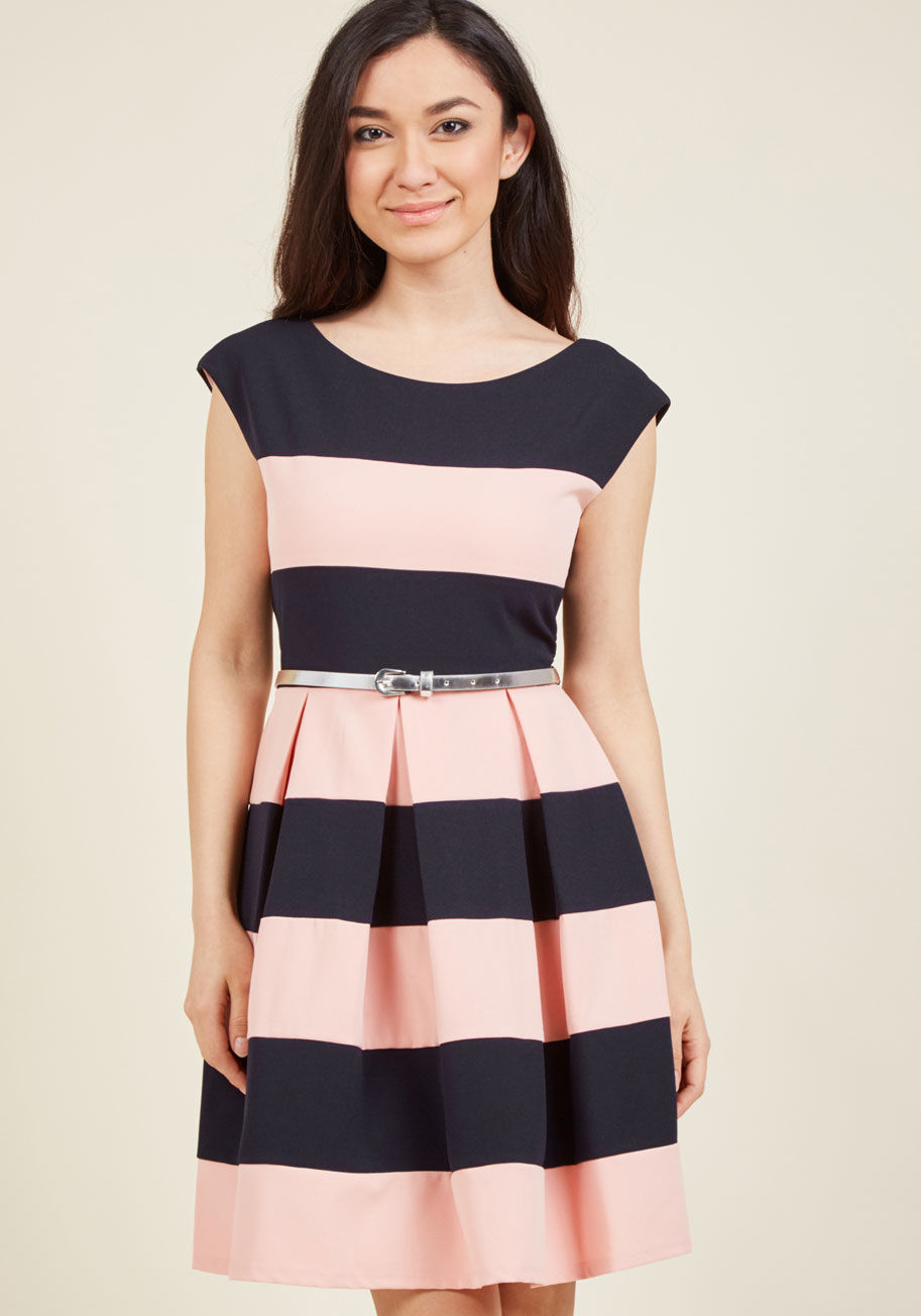  - Coordinate with your bestie to fill the weekend with plans befitting of this black-and-pink striped dress! Brilliance bubbles from its sweet cap sleeves, elegant scoop back, shiny silver belt, and classic skirt pleats, meaning you'll ignite the scene with