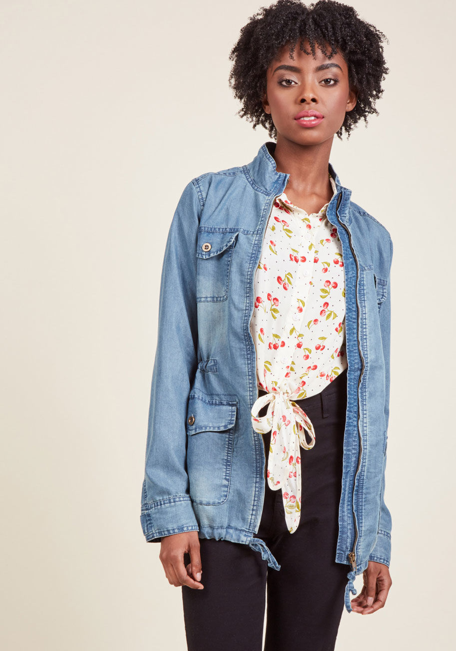 Countryside, coast, city, or savanna, this chambray jacket is great to have on hand! Boasting buttoned pockets at the chest and hips, drawstring ties at the waist and hem, and a zipper running right up the center of its stand-up collar, this versatile ano by 