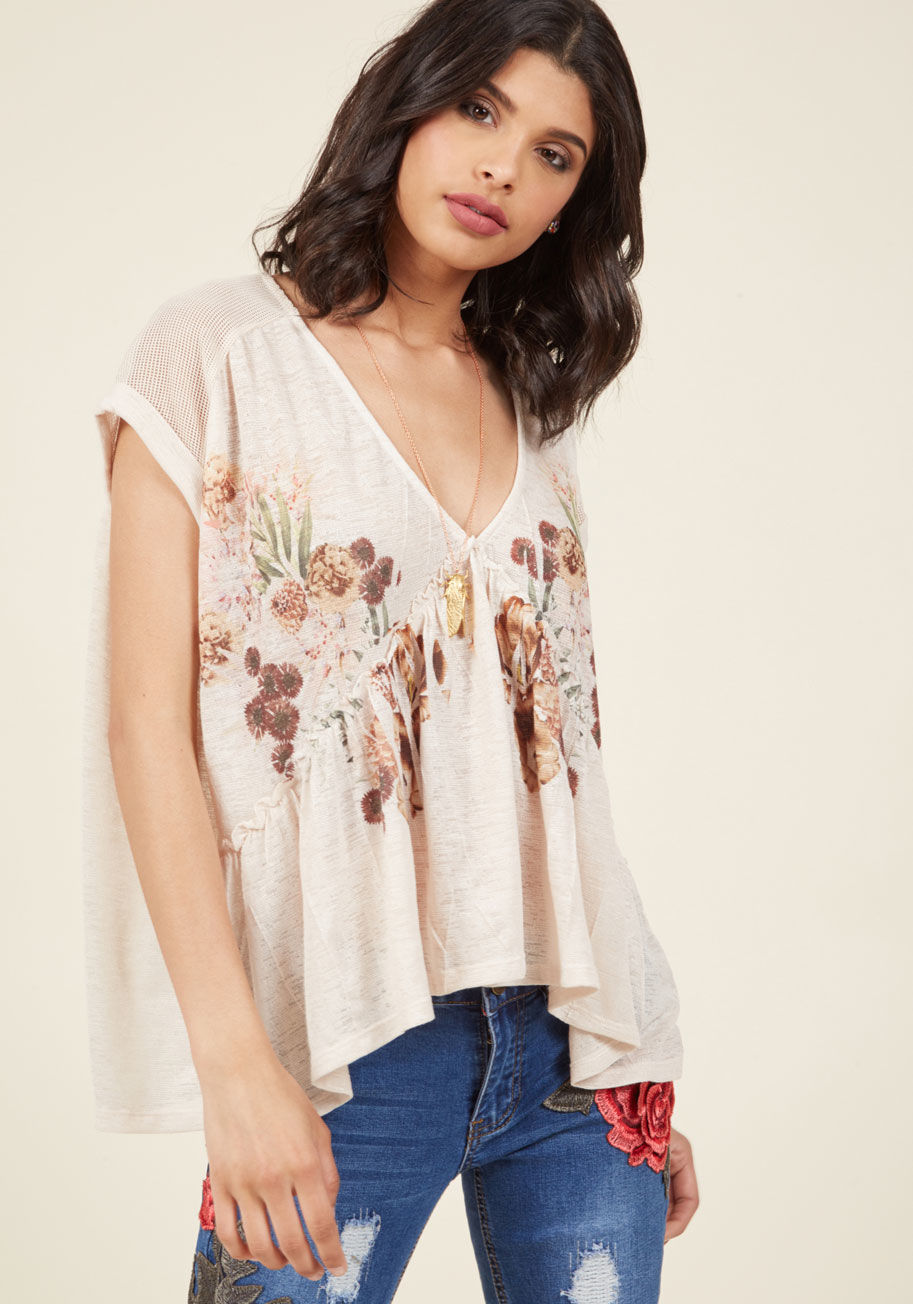  - Debating how to spend a sunny afternoon, you look to this ivory top for guidance. It's the muted floral print of this V-neck beauty that inspires you to seek out your favorite flowers, and as an added bonus, its mesh-paneled back, cuffed sleeves, and bree