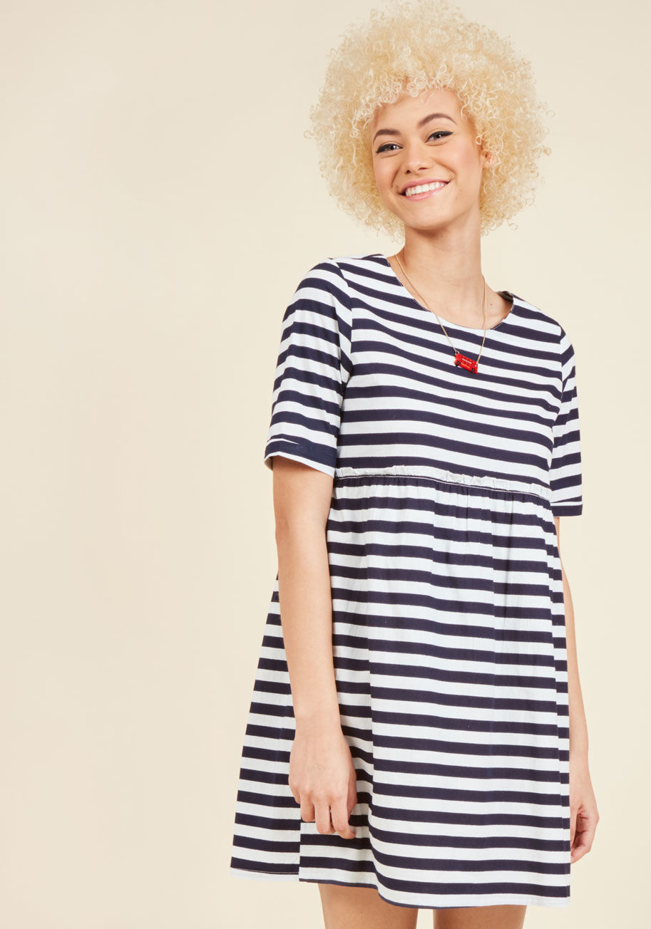  - Do you love a fluttering hem, a subtle hint of femininity, and stylish sweetness? Then, this navy and white babydoll dress from Compania Fantastica is a must-have! The exposed, ruffled seam of this half-sleeved frock only adds to its charm, making this st