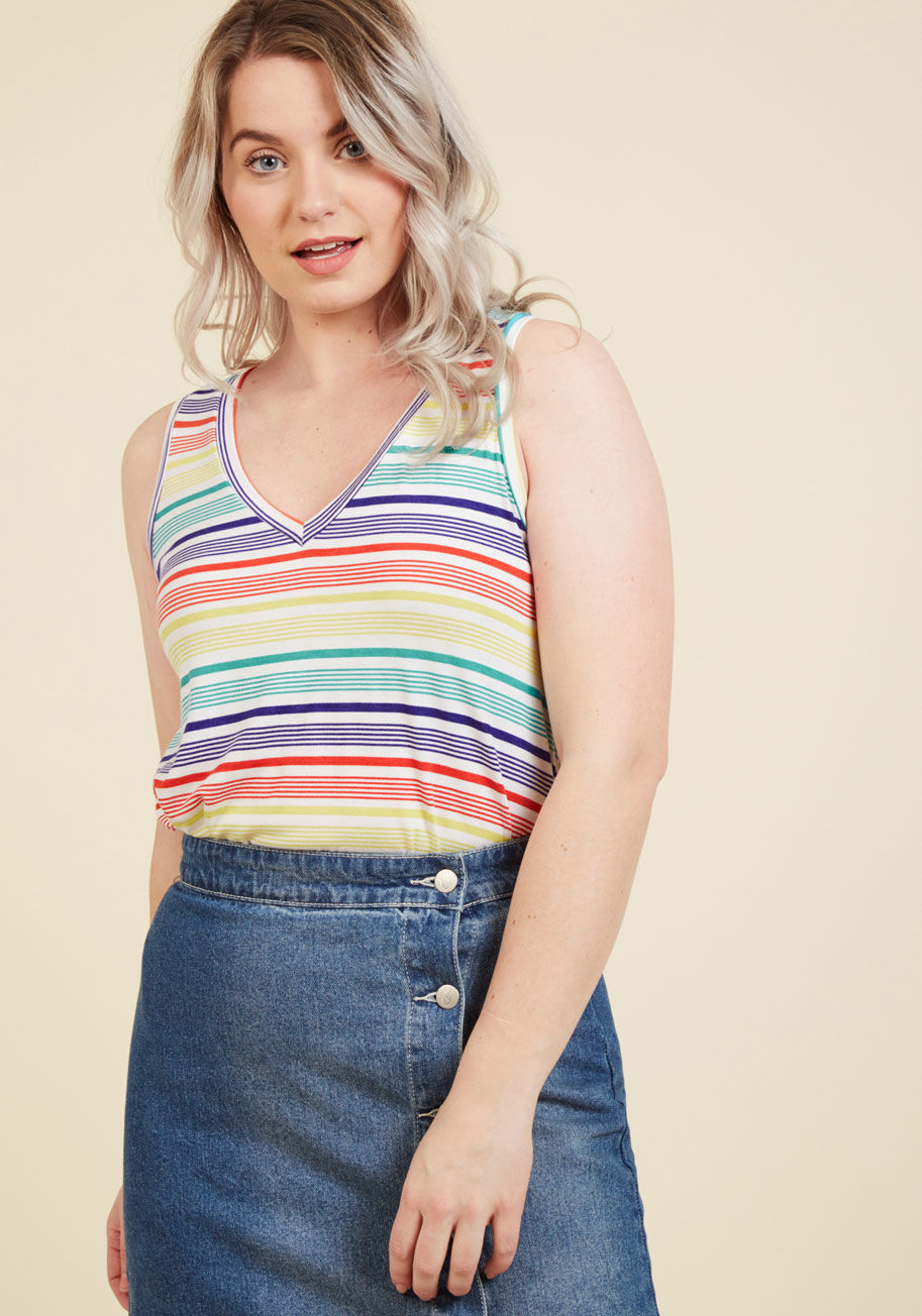 - Every fashionista knows the necessity of pieces that can be infinitely styled, and this navy blue top promises unlimited options. This V-neck's high-low hem and ultra-soft jersey knit pair with a red, white, and lime green heart pattern to assure boundles