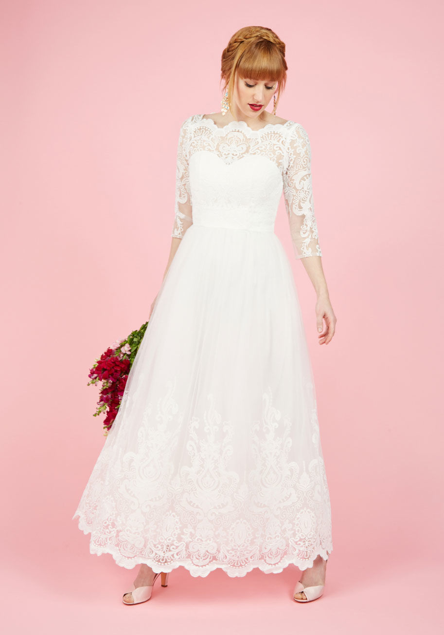  - For an occasion unlike any other, this white gown by Chi Chi London is sure to dazzle. Elegant embroidery both bedecks the bodice of this dress and swirls up the hemline of its voluminous tulle skirt. With an illusion, sweetheart silhouette below its bate