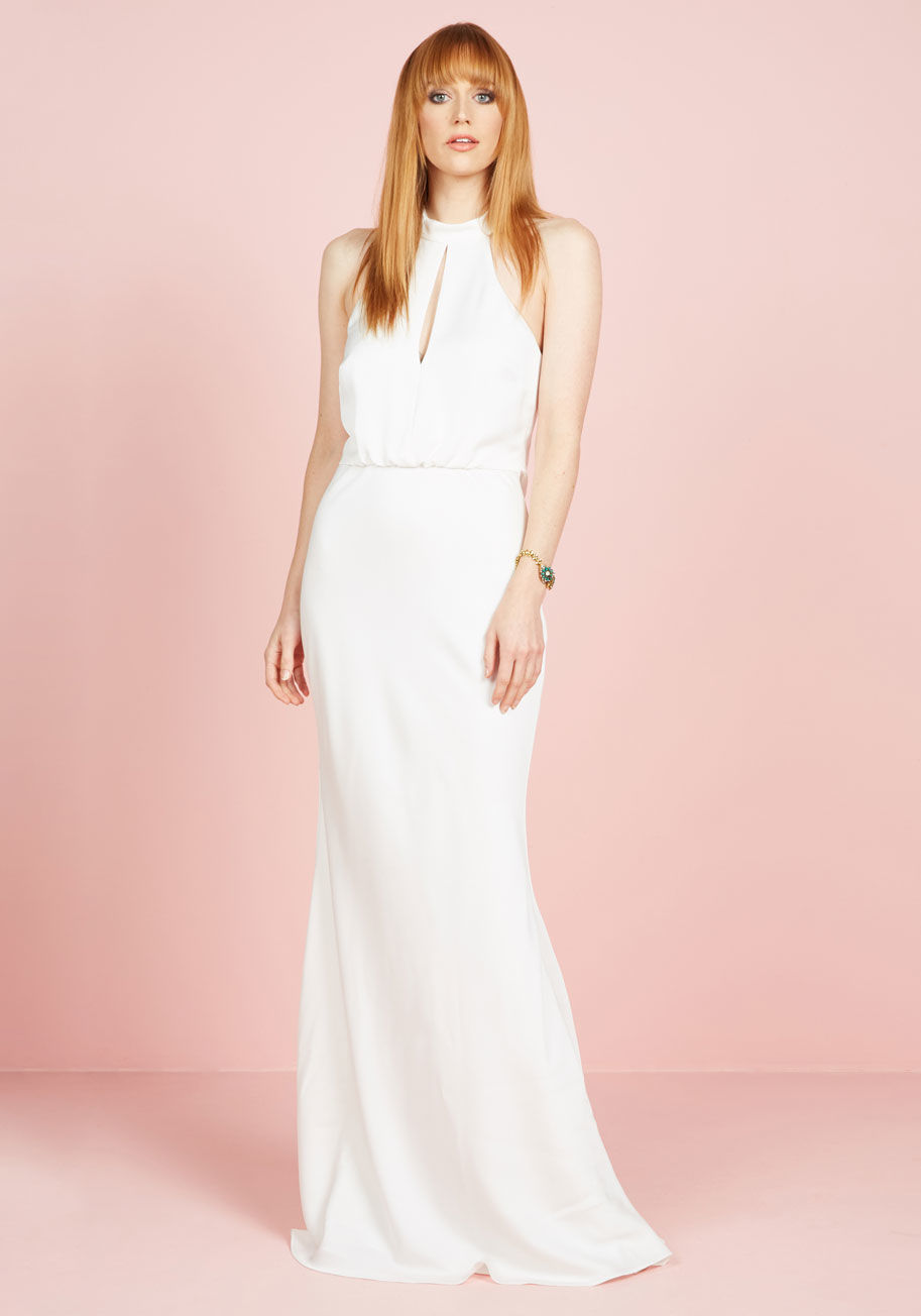  - From the first sight of you at the end of the aisle &lsquo;til the limo takes you to your sweetheart suite, this slinky white gown completely captivates. Melding romance with sultry style, this bridal beauty features a tapered neckline with a front keyhol