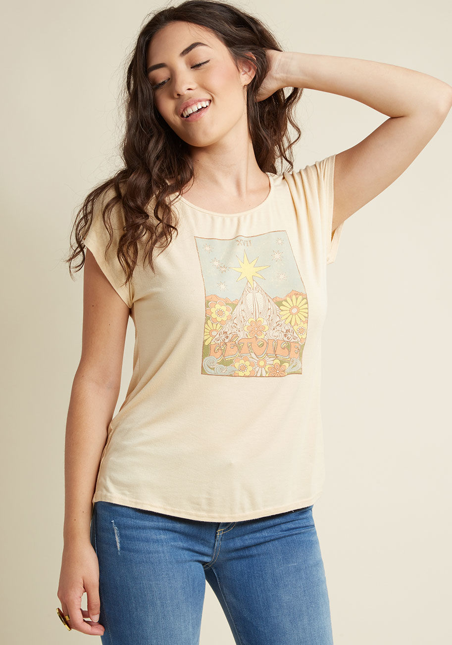  - If this yellow T-shirt doesn't fill you with wanderlust, then we don't know what will! A ModCloth exclusive, this jersey knit tee motivates you to explore your surroundings with its loose fit and bohemian graphic of flowers, swirls, and celestial bodies a
