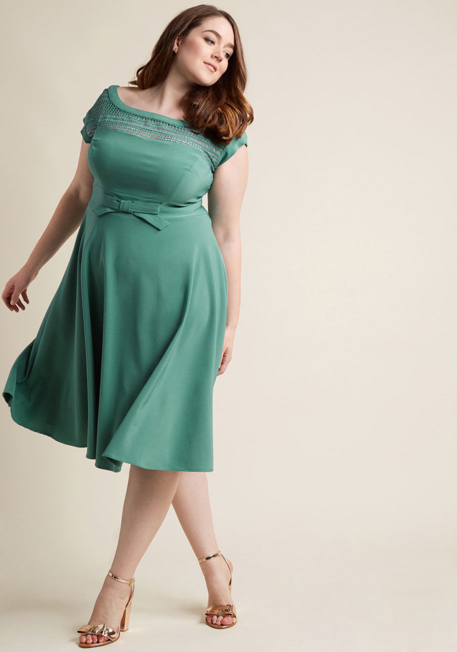  - If you're going to give your most coquettish expression, you might as well lend it as an accessory to this navy dress! Made stunning from a bateau neckline detailed with geometric lace, a waistline bow, and a swingy midi skirt touched with stretch, this r