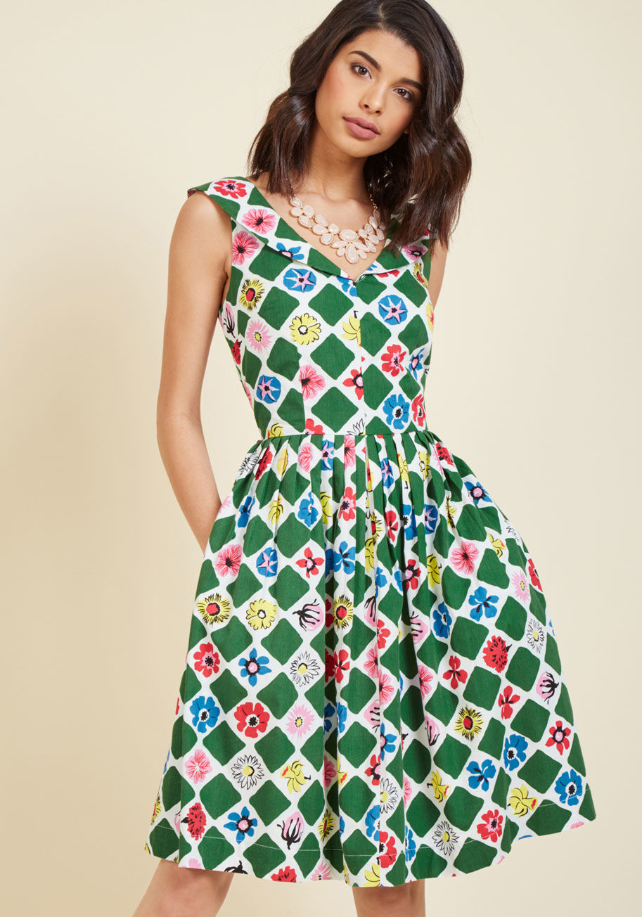  - If you're rarin' to rock something retro, then this cotton dress will rile you up! Offered by hard-to-find British brand Emily and Fin, this pocketed midi dress uses a collared V-neckline, plentifully pleated waistline, and colorful diamond-and-flower gar