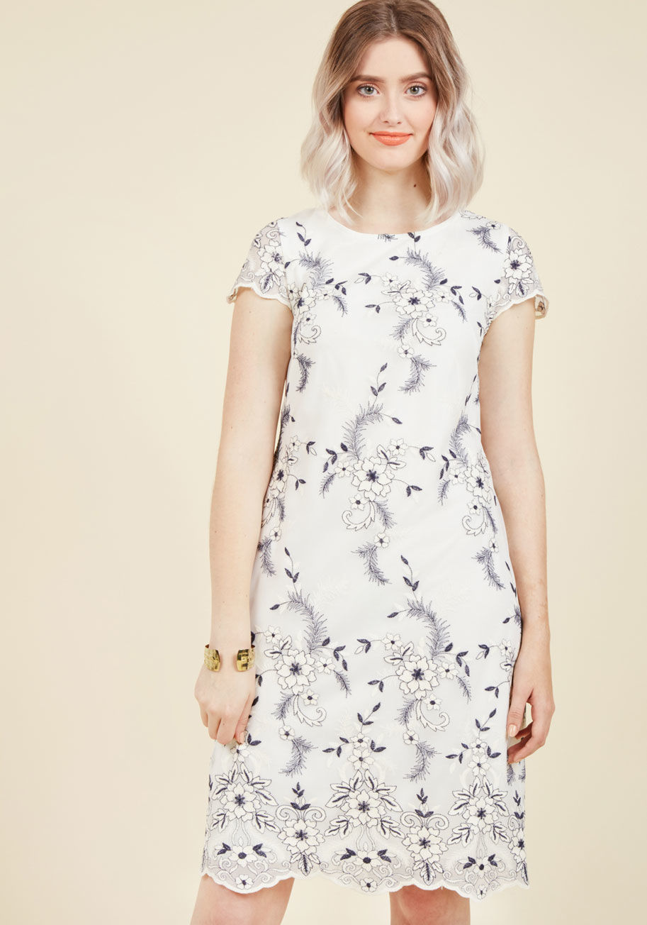  - In this white sheath dress, you exemplify the sophistication expected at such affairs! Between sips of jasmine tea and crumpet nibbles, your company compliments the scalloped cap sleeves, navy-accented floral embroidery, and sweet chicness of your refresh