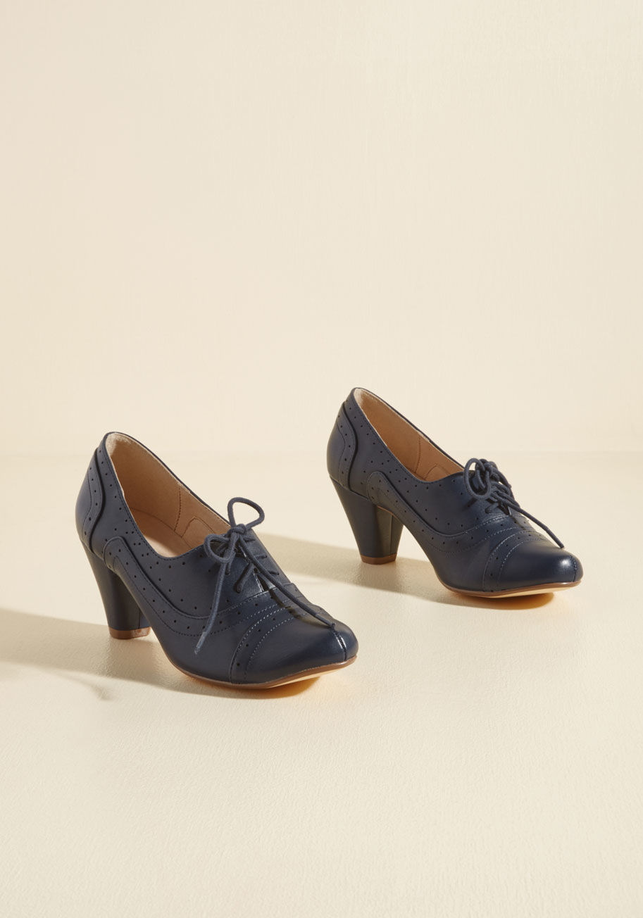  - In your effort to look sharp, these faux-leather pumps have you off to a good start! Timelessly touting tapered heels, perforations, and slightly pointed toe caps, this lace-up pair is prepared to perfect many a sophisticated ensemble.