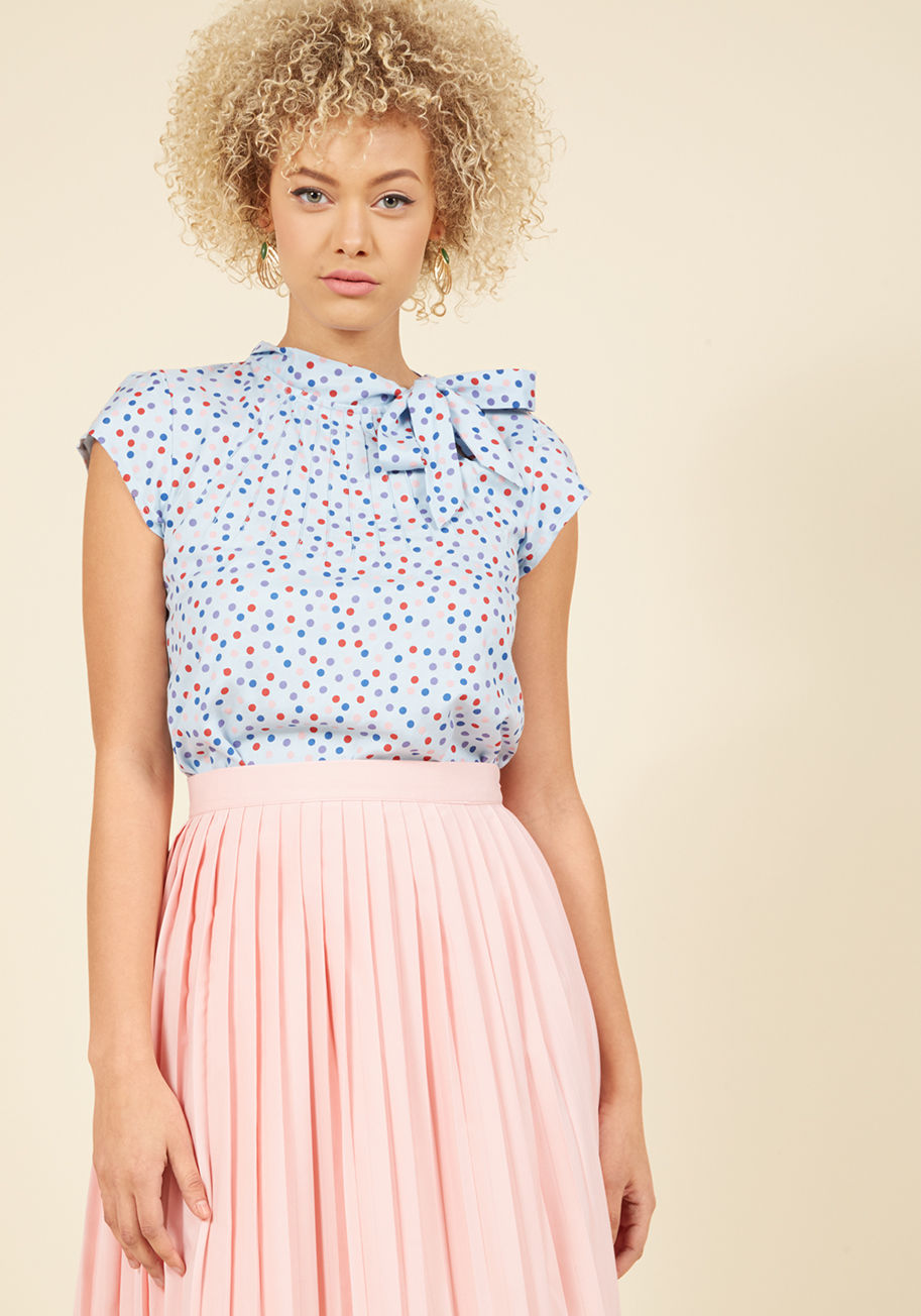  - It&rsquo;s a bird! It&rsquo;s a plane! No, it&rsquo;s the lofty and lovely feeling inspired by this bold orange blouse! A print of white leaves graces this cap-sleeved top, while a neck tie and pintucking elevate your look to new atmospheres of elegance.
