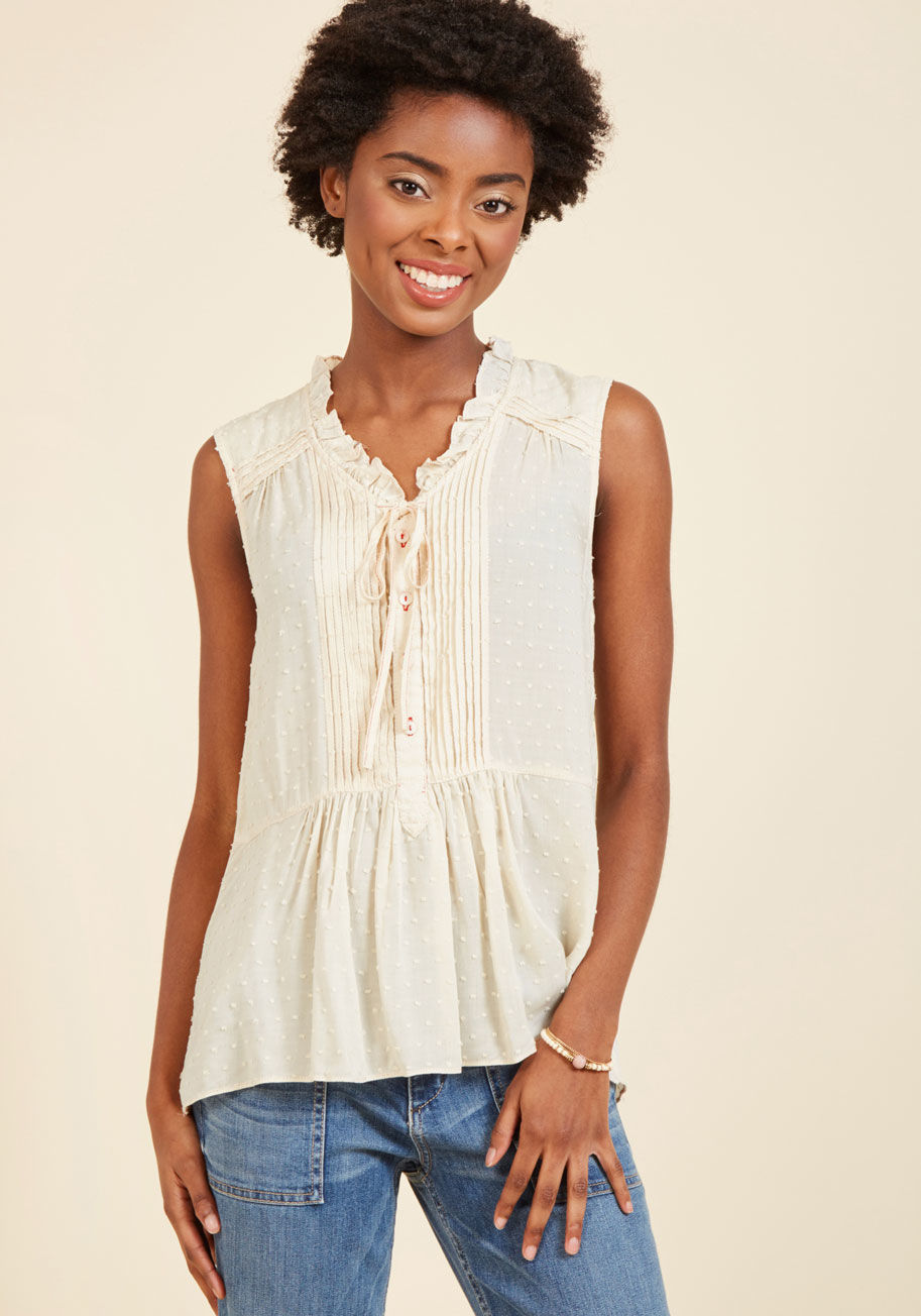  - It's hard work to find the perfect blouse, but once you discover this ivory top, you'll only have eyes for its design! A showcase of your most beloved details, this piece's ruffled neckline, pintucked shoulders and placket, swiss dots, and peplum waist ma