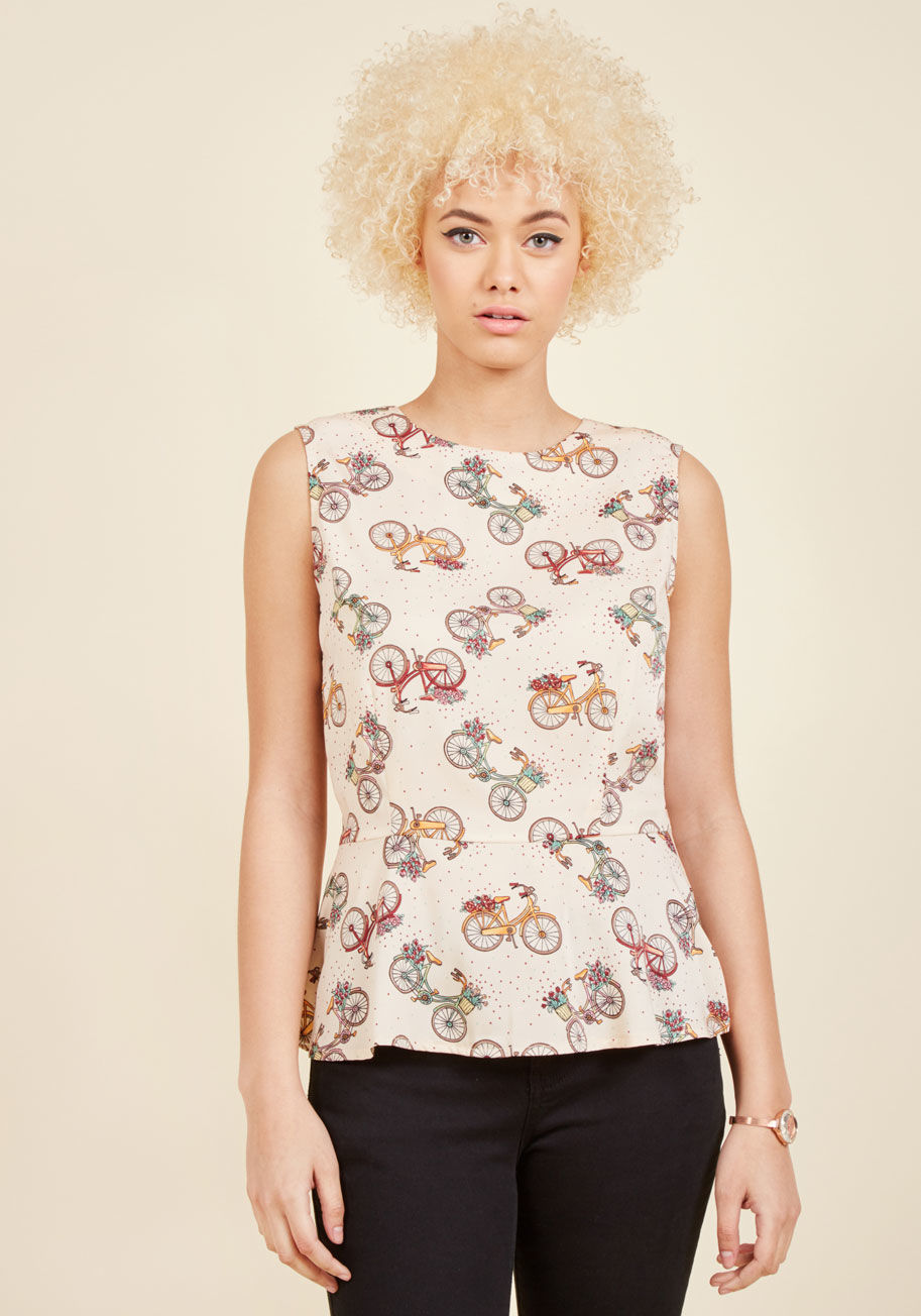  - Make every trip a treat by sporting this tan top by Banned! Decorated with maroon and mint polka dots, boasting a peplum waistline, and infused with charm from the beautiful bike and lush bouquet print, this silky blouse has serious style that lasts for m