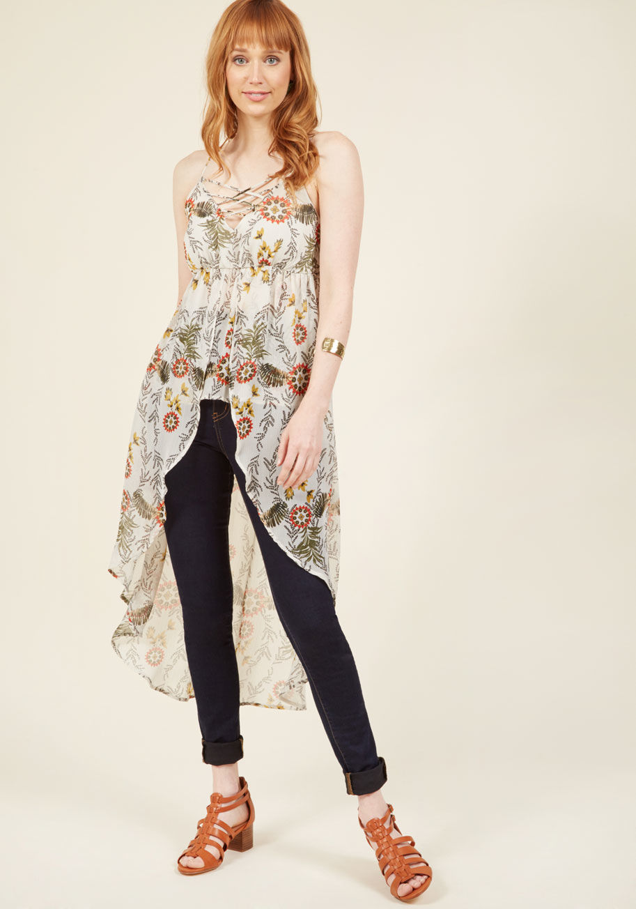  - Naturally you've mastered a balance between drama and subtlety through this ivory tank top! The crisscross neckline and high-low hem of this incredible piece blend masterfully with its breezy fabric and muted floral print