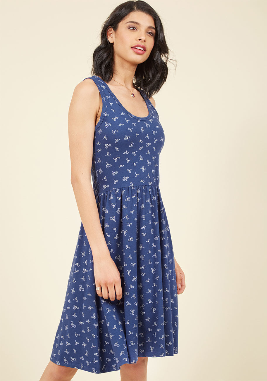  - Now that you have your plans prepped, it's time to organize this navy blue dress into as many vacay ensembles as humanly possible! With a scoop neckline, a sweet white sprout print, and a gathered waist, this jersey knit frock from Mata Traders is sure to