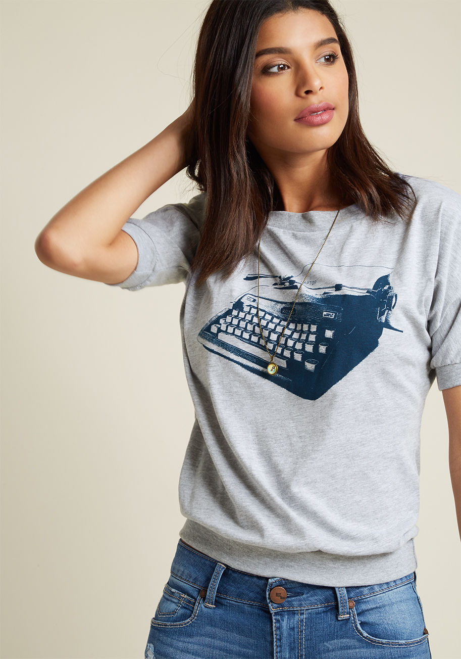  - Penning a chapter a day will take discipline. And a whole lot of coffee. Set up your scribing stage by pouring yourself a double shot of espresso and tossing on this heather grey tee! Featuring a navy, vintage typewriter graphic, ribbing at the sleeve cuf