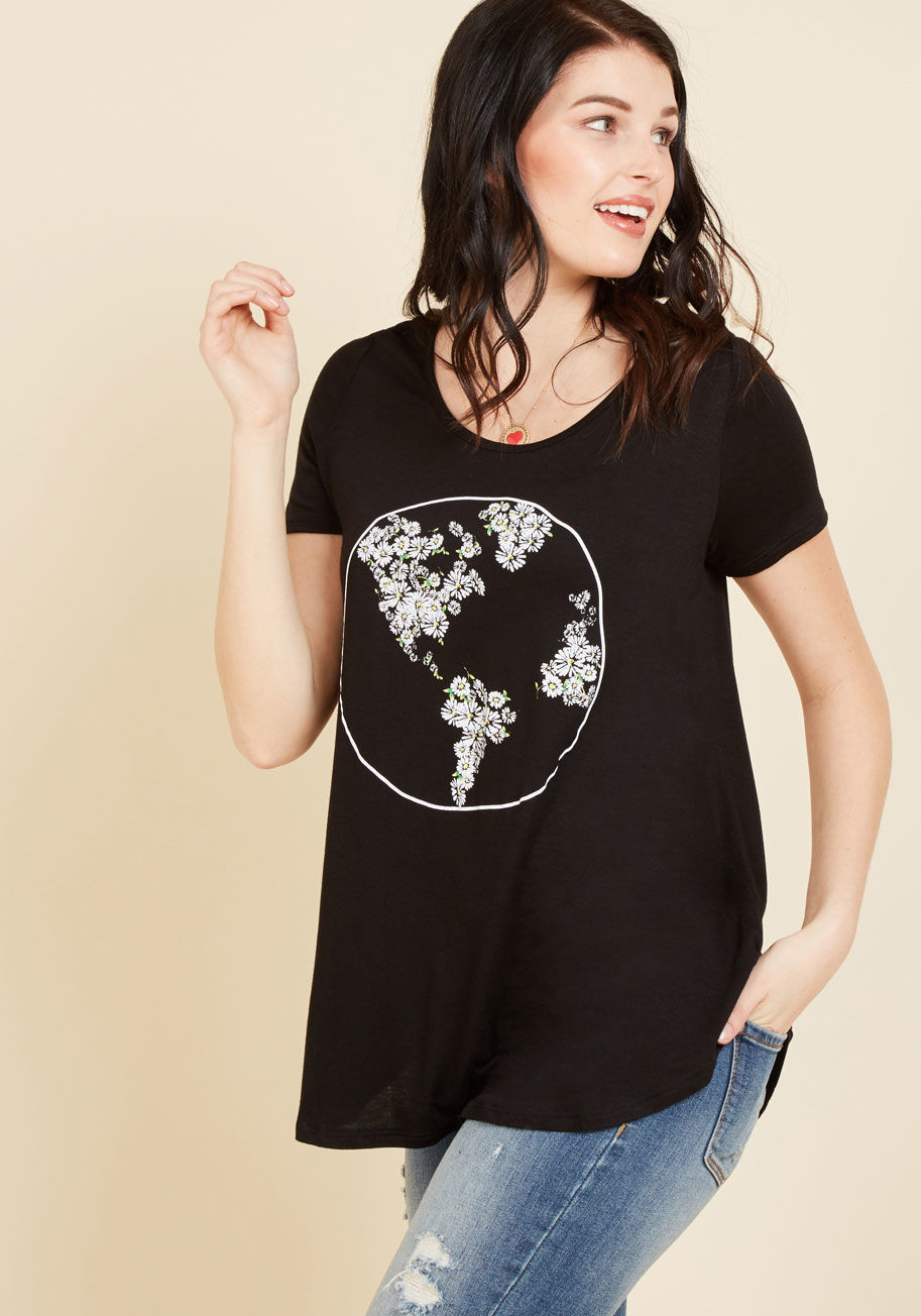  - People will gather from all over the globe to adore this black tee! A floral interpretation of the earth is screen printed