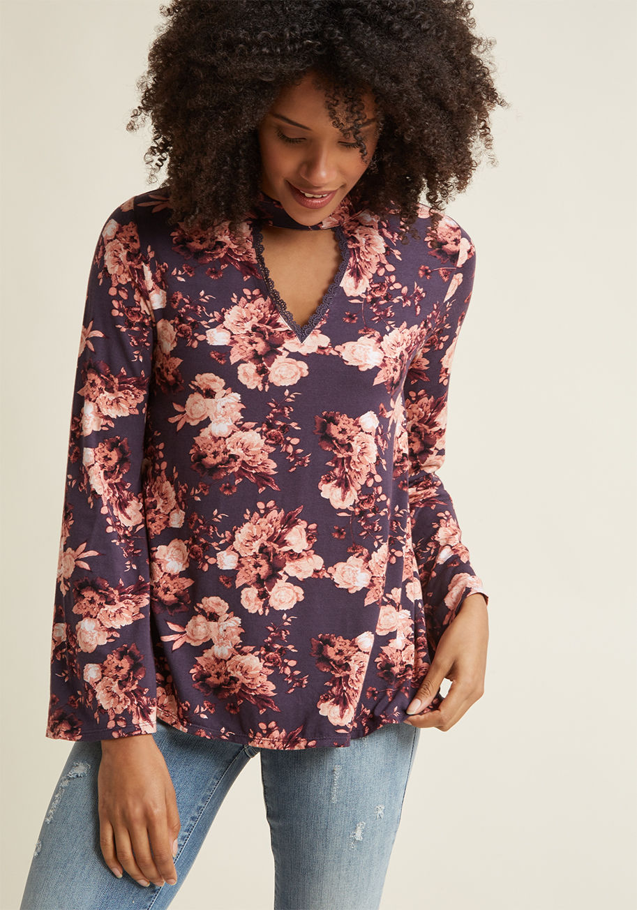  - Pioneer your own unique brand of intrigue with the assistance of this floral top! Boho-inspired and undeniably beautiful, this jersey piece gently catches everyone's attention with its high neckline atop a deep keyhole, crochet trimmings, bell sleeves, an
