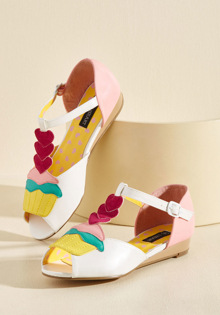 - Put a &lsquo;merry&rsquo; on top of an already sweet day by stepping into these white wedges. Boasting cupcakes, layered hearts, and topstitched accents