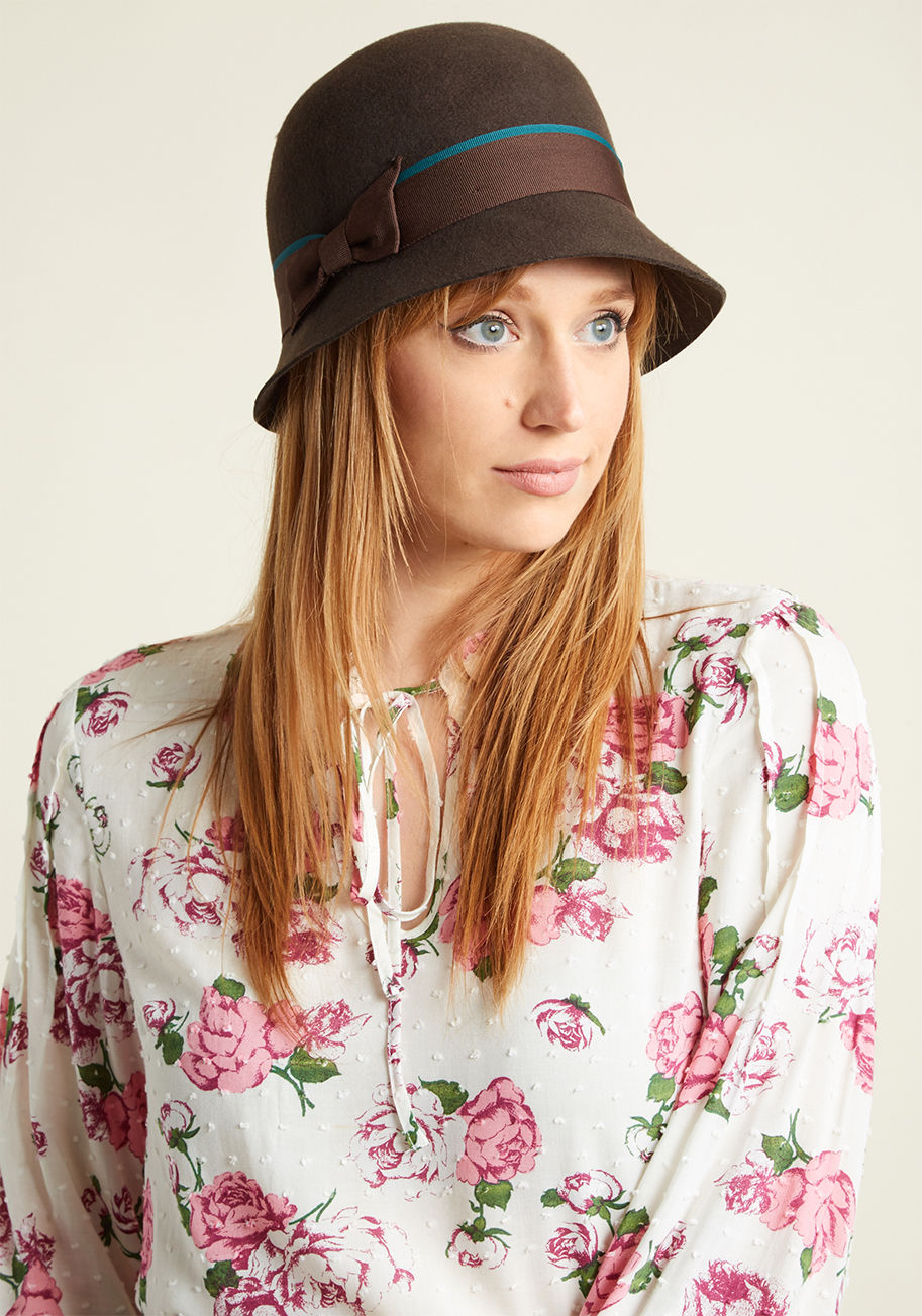 Remember when you let the perfect cloche hat get away? Don't let the same thing happen twice! This brown wool chapeau - with a grosgrain ribbon trimming its circumference, a bow securing its ends, and a teal accent band adding extra panache -will feel lik by 