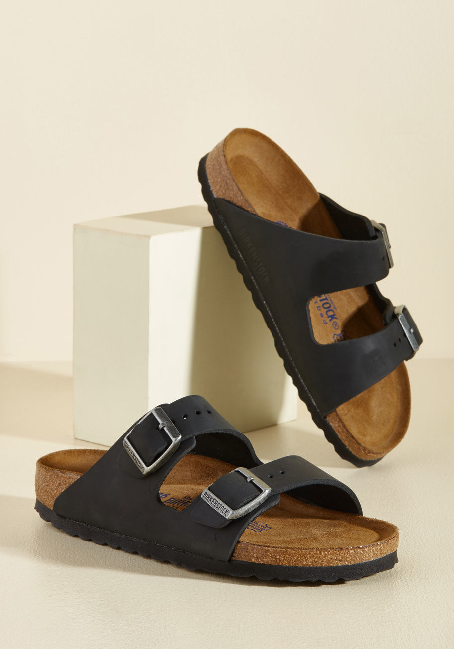  - Set up your tent, kick off those hiking boots, and step into these Birkenstock Arizona sandals! This black leather pair features a molded cork footbed with pronounced arch support, a deep heel cup, and a roomy toe box - keeping your feet cozy and content.