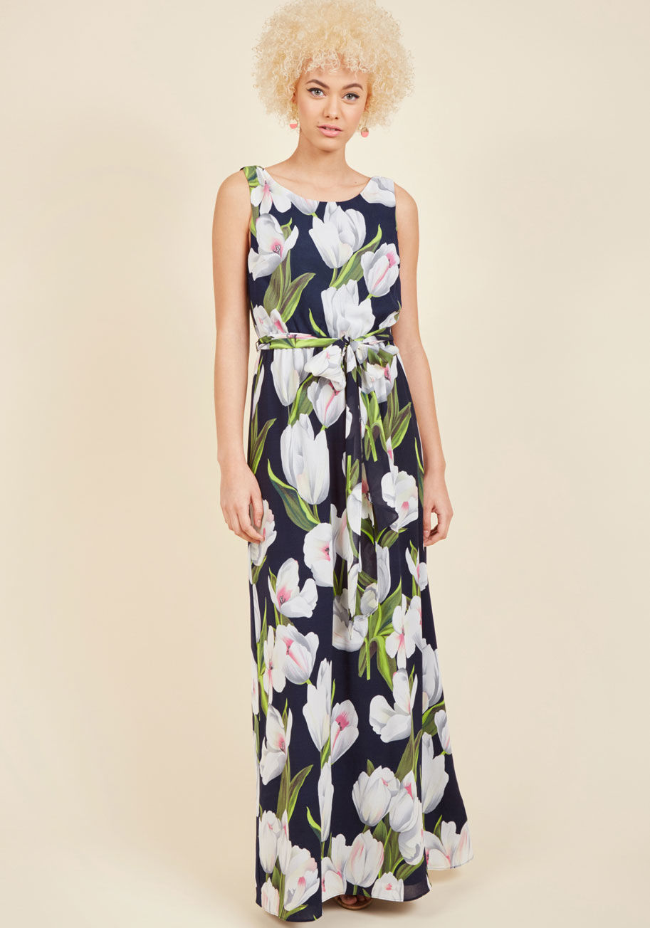  - Some see soirees as mere opportunities to look pretty, but you don this navy blue maxi dress with networking