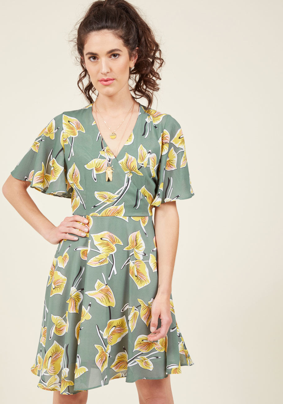  - Sometimes the biggest statement you can make is one of freedom and flirtation! This sage green dress from Canadian brand Pink Martini embodies exactly that. Fluttering sleeves, a snap-secured surplice neckline, and a swingy A-line skirt give this frock it