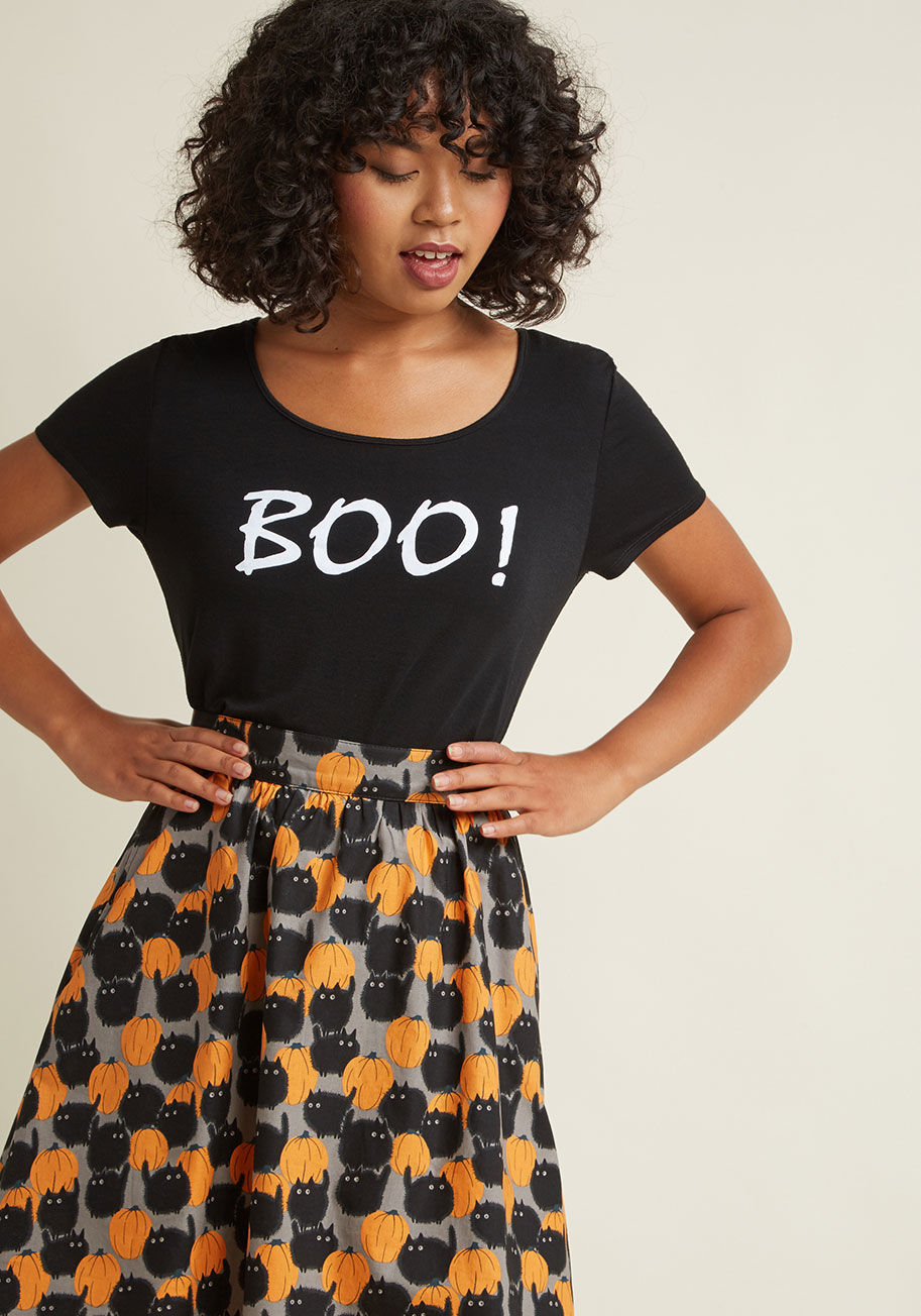  - Take care to greet friends with hair-raising enthusiasm, courtesy of this black T-shirt! This ModCloth-exclusive top's loose silhouette is completely comfy, while its glow-in-the-dark, white Boo! screen print offers a chillingly cute element to your casua