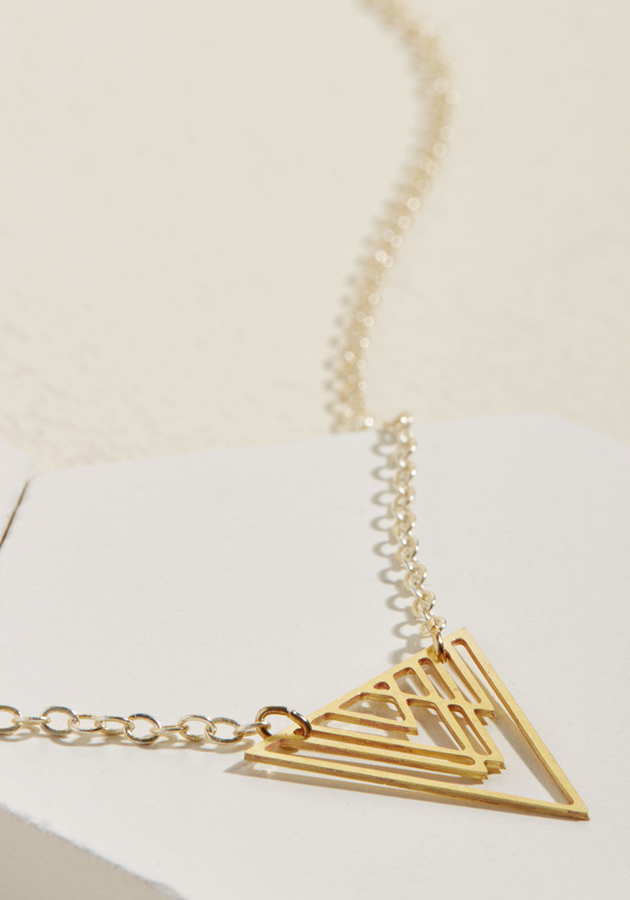Tall peaks and rugged ranges impress you so, and this gold necklace brings that awe to street level. A pendant of dangling triangles exudes geometric grandeur on this angular accessory, igniting inspiration by 