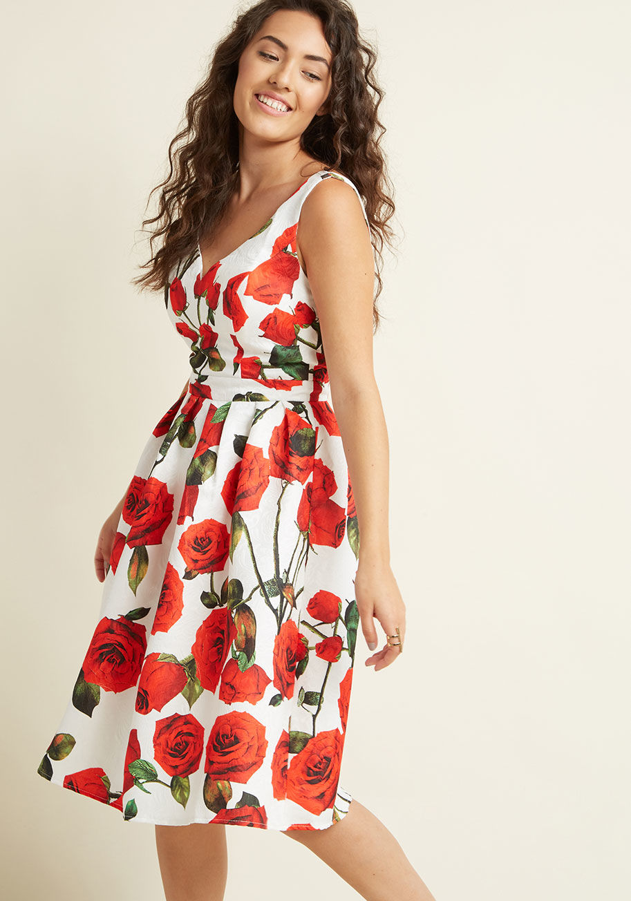  - The perfect time has arisen to wear this floral midi dress from Chi Chi London and, my, how you match the decorous gathering perfectly. This retro A-line&rsquo;s textured white and red fabric, graceful V-neck, padded bust, and pleated skirt create a class
