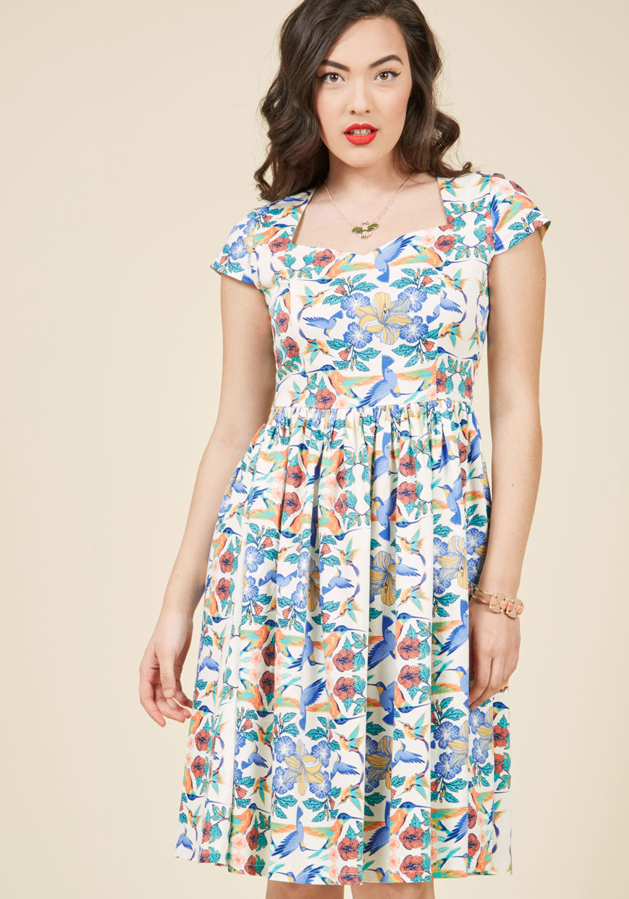 - There are plenty of vintage-inspired blouses out there, but none quite as charming as this ivory top by Banned! Catering to your specific taste with its white collar, accent tie, tulip sleeves, and radiant print of hummingbirds and lively blossoms, this n