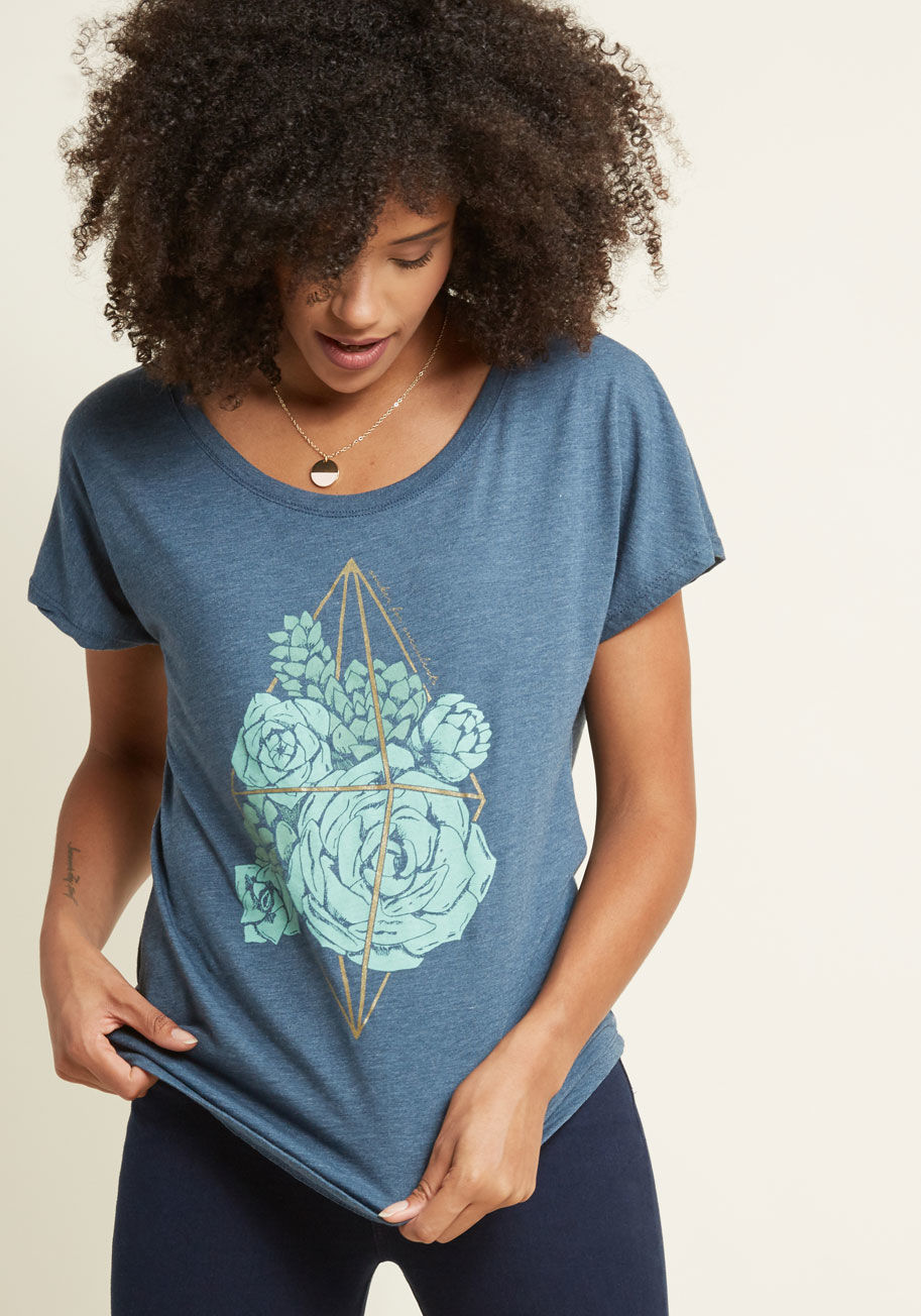  - There's just something about a well-placed succulent, and the aqua plants printed on this heather blue T-shirt are an exemplary example of that concept! Caged inside a metallic gold terrarium and quietly claiming yourself as a sucker for succulents