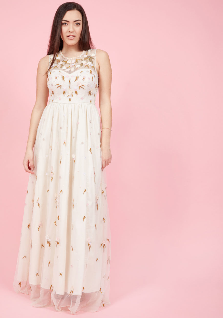  - There's really nothing to it - this eggshell gown is the most breathtaking embodiment of elegance imaginable! Vanilla, white, and pink flower appliques drift down this bead-sprinkled bridalwear, clustering at the illusion neckline and making way for a del