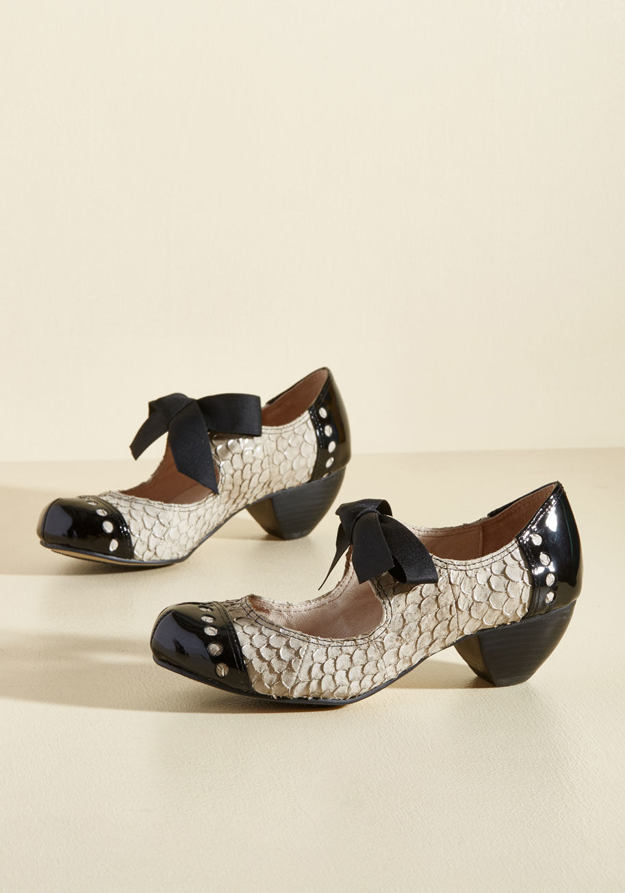  - These spiced-up Mary Janes are a royal blue pair you&rsquo;ll want to wear everywhere. They boast textured, scalloped vamps worth admiring, black patent leather toe caps and heels touting perfectly round cutouts, and satin ribbon closures that look cute a