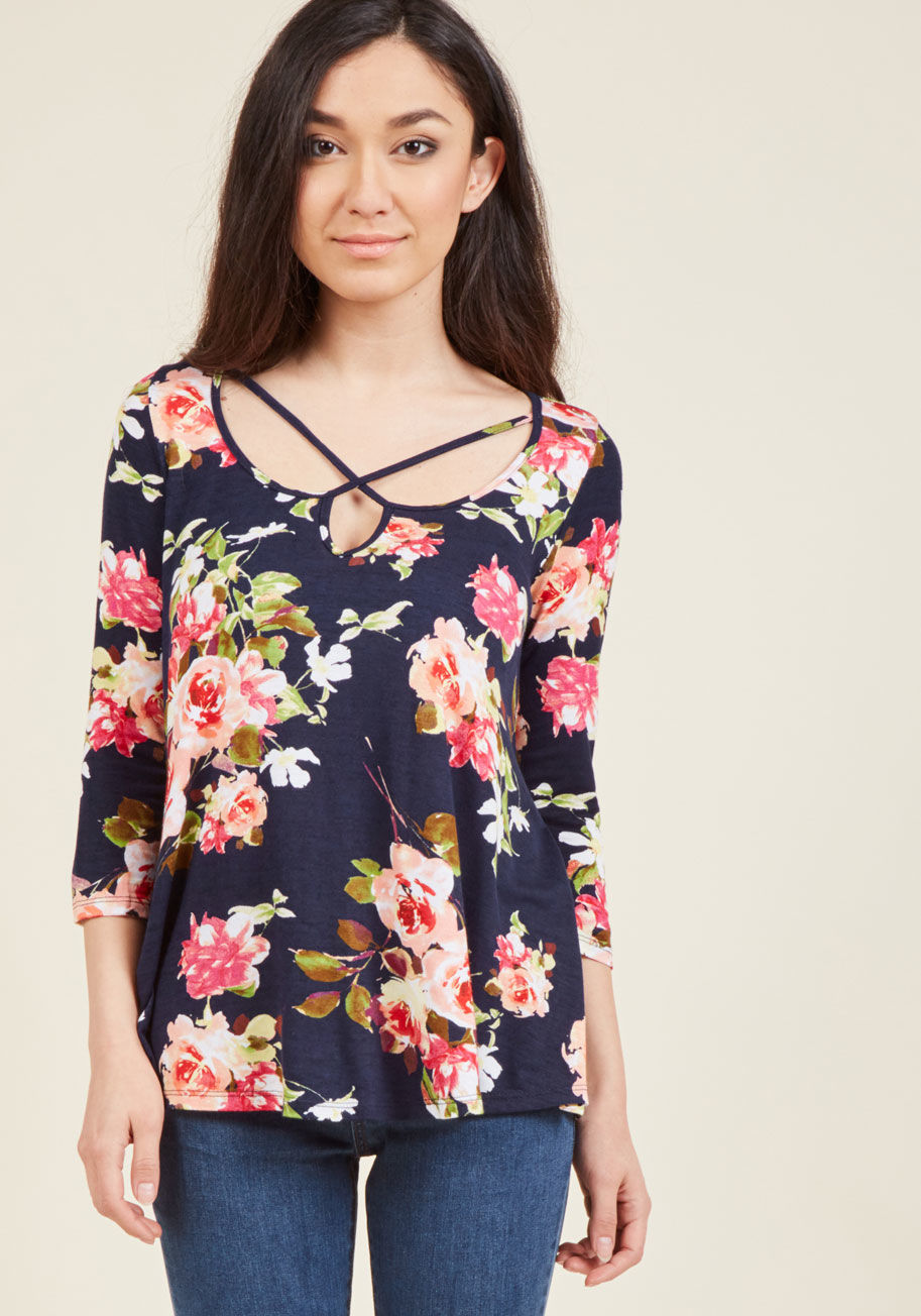  - Think the lush floral print, flowing silhouette, and ultra-soft fabric of this navy blue top make it the loveliest outfit option around? Well, with the addition of its crisscross straps at the neckline, it certainly is! Meeting at the points of adorable a