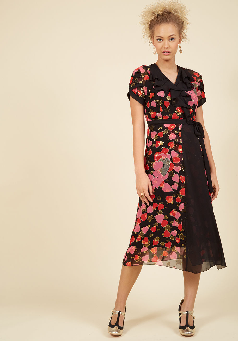  - This black wrap dress by Anna Sui meets at the intersection of luxurious and lighthearted - your two favorite design perspectives! Tulip-style sleeves and a ruffled neckline offer classic, feminine touches to this silk midi, while its red-and-pink heart p